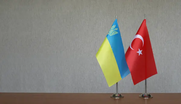 stock image Tabletop flags of Ukraine and Turkey on a gray blurred background