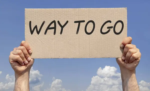 Stock image Hands holding a piece of cardboard with the inscription 