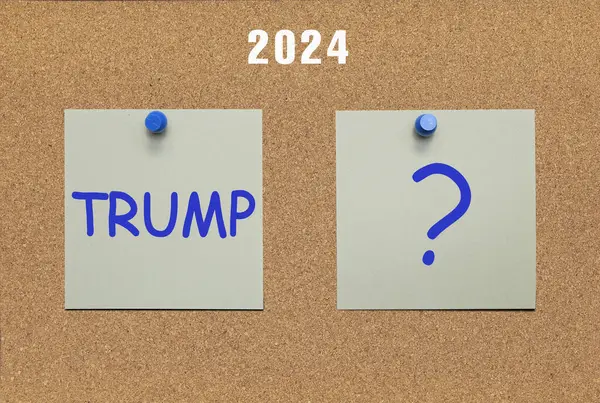 stock image Two sheets of paper on a cork board with the words Trump and a question mark written on them