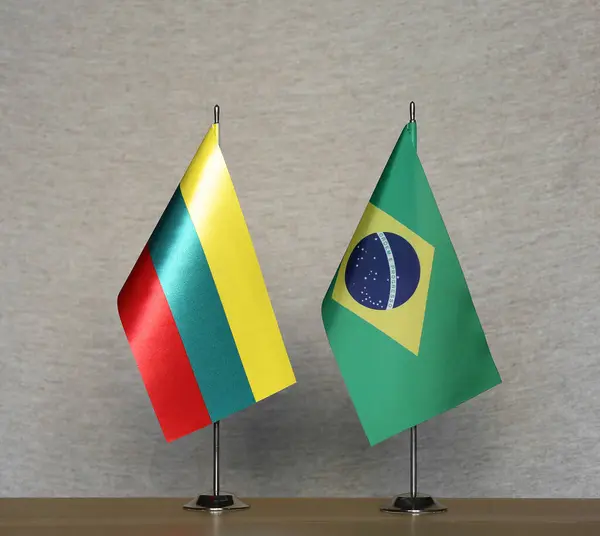 stock image Table flags of Brazil and Lithuania on a gray blurred background