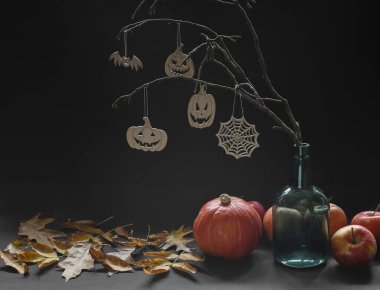 Balkabağı, elma, şişe ve bayram sembolleriyle Cadılar Bayramı kompozisyonu