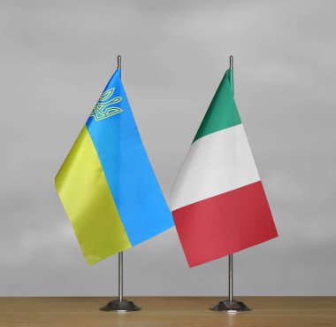 Gri arka planda Ukrayna ve İtalya 'nın masa üstü bayrakları