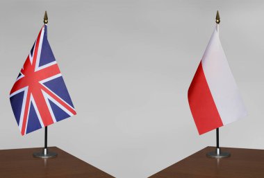Birleşik Krallık ve Polonya 'nın masa üstü bayrakları gri bir arka planda duruyor
