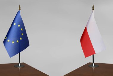 Avrupa Birliği ve Polonya 'nın bayrakları gri arka planda duruyor