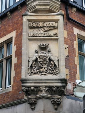 Chester, Cheshire, United Kingdom - 20 March 2024: Stone sign above the entrance of the Historic Grosvenor Hotel in Chester England clipart