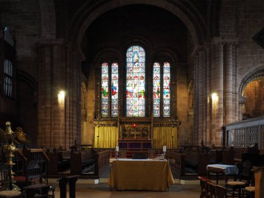 Chester. Cheshire, United Kingdom - 20 March 2024 : The alter and stained glass windows in St John the Baptist's Church, Chester clipart