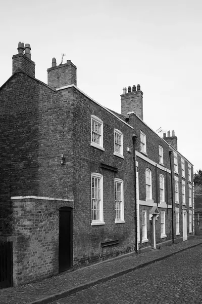 Stock image monochrome image of a street of old traditional red brick Georgian houses on a cobbled road in Chester England