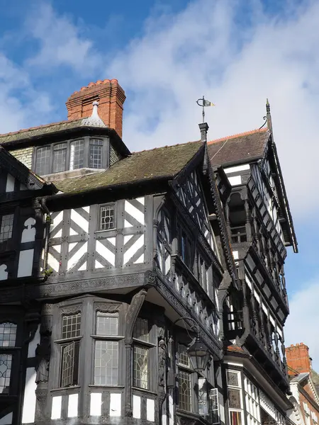 Stock image Typical large old half timbered tudor building in Chester city centre with overhanging bays and brick chimneys