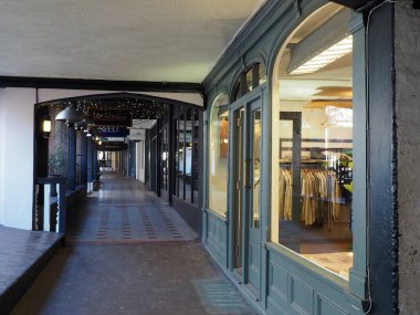 Chester, Cheshire, United Kingdom - 20 March 2024 : shops on watergate row, a historic upper level covered row of shops on watergate street above street level clipart