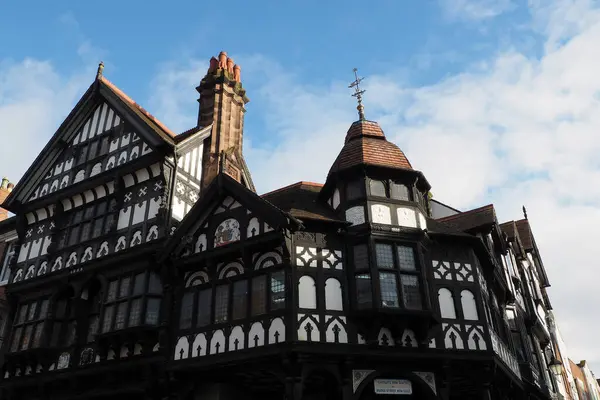 stock image Old half timbered buildings on the corner of Eastgate and bridge street with stairs leading to the upper rows in Chester