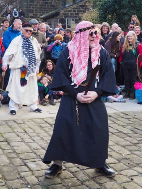 Hebden Köprüsü, Batı Yorkshire, Birleşik Krallık - 29 Mart 2024: Heptonstall West Yorkshire 'daki Weaver Meydanı' nda geleneksel iyi Cuma temposunda oyuncular ve seyirciler