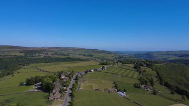 Yeşil ağaçlar ve tarlalarla güzel bir kır manzarası.