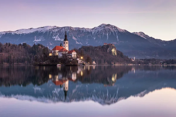 stock image Morning reflections at Lake Bled with Bled Island and Bled Castle in the background.