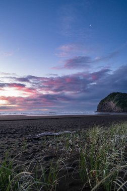 Gorgeous sunset cloud formations at the North Piha Beach clipart