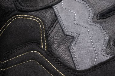 black leather motorcycle gloves. background or texture