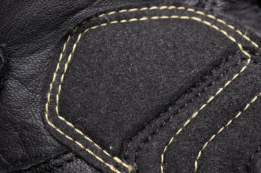 black leather motorcycle gloves. background or texture