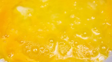 beaten egg yolks with visible texture.background