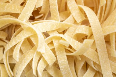 yellow pasta with visible details. background or texture