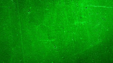 İlginç desenli yeşil boyayla boyanmış bir duvar.