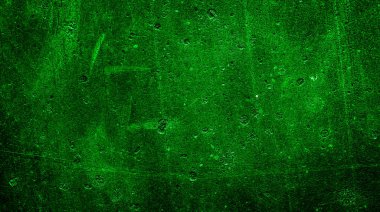 İlginç desenli yeşil boyayla boyanmış bir duvar.