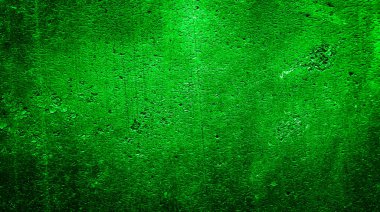 İlginç desenli yeşil boyayla boyanmış bir duvar.