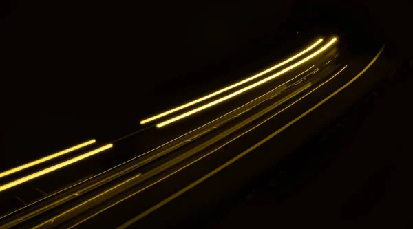 stock image yellow car lights at night. long exposure