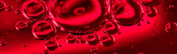oil drops on water on red background