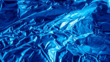 blue aluminum foil with a visible texture. background