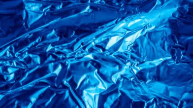 blue aluminum foil with a visible texture. background
