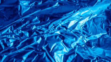 blue aluminum foil with a visible texture. background