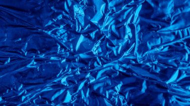 blue aluminum foil with a visible texture. background