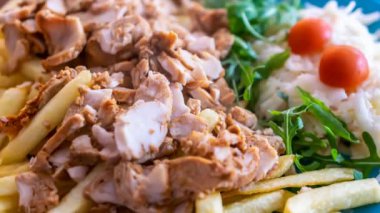  kebab with potato fries and salad on a blue plate