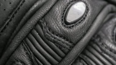 black leather motorcycle gloves. background or texture