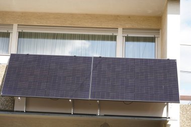 Balkon enerji santralinin güneş modülleri kızgın güneş tarafından aydınlatılır. Güneş panelleri gün ortasında çok elektrik üretiyor.