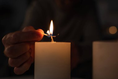 Siyah arka planda yanan kibrit yakan adamın kırpılmış görüntüsü