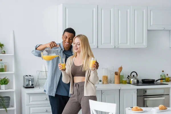 Happy African American Man Pouring Orange Juice Pretty Girlfriend Holding — Stock Photo, Image