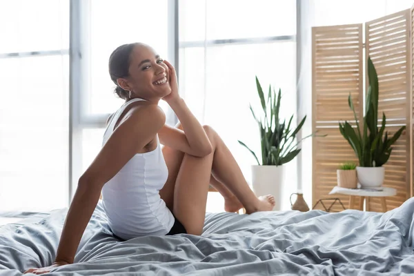 Pleased African American Woman Tank Top Sitting Bed Home — Stock Photo, Image