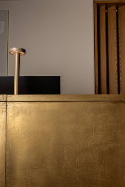 computer monitor near modern golden lamp on reception desk of luxury hotel 
