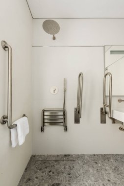 interior of white bathroom for disabled people in hotel 