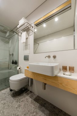 interior of modern bathroom with white clean glasses near sink