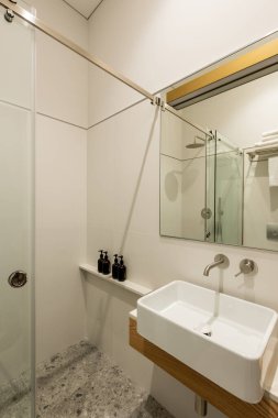interior of modern white bathroom with toiletry near white sink 