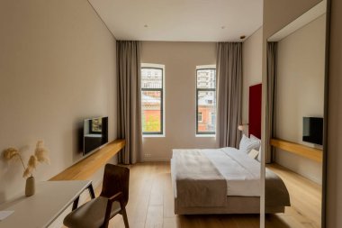 yellow envelope on comfortable bed in modern hotel room 