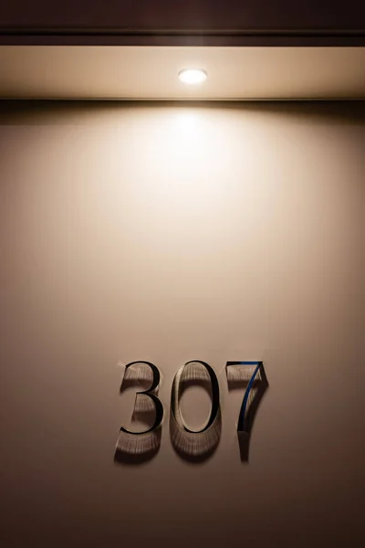 Stock image room door with three hundred and seven numbers in hotel 