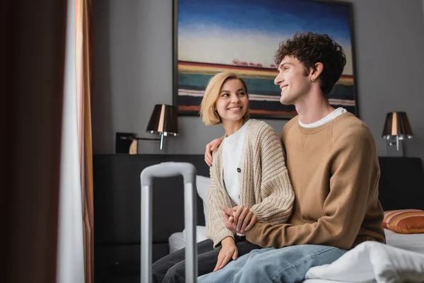 Cheerful Blonde Woman Looking Smiling Boyfriend Hotel Bedroom Blurred Foreground — Stockfoto