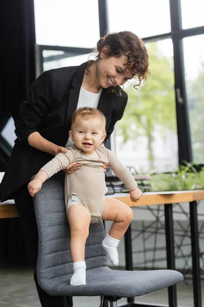 Happy Businesswoman Black Suit Holding Little Daughter Office Chair — Fotografia de Stock