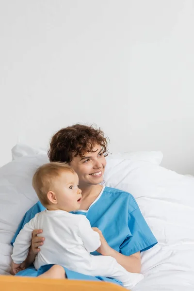 Pleased Woman Toddler Girl Open Mouth Looking Away Bed Hospital — Stock Fotó