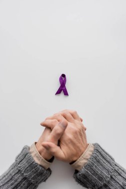 top view of cropped senior man near purple alzheimer disease awareness ribbon on white background with copy space