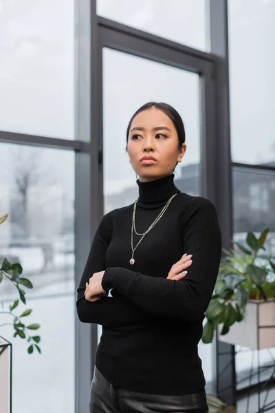 stock image Young asian designer crossing arms while standing in office 