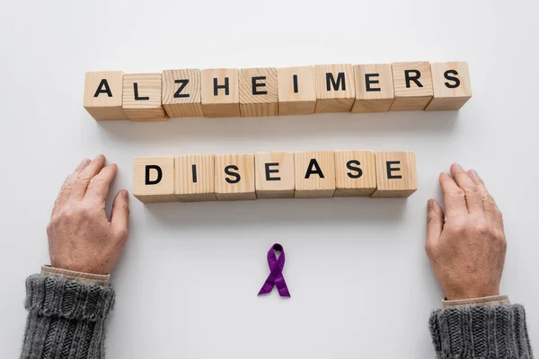 Top View Cropped Senior Man Purple Ribbon Wooden Cubes Alzheimers — Stockfoto