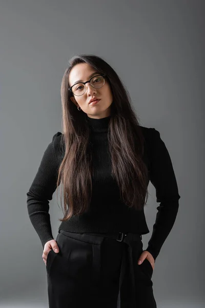 Portrait Brunette Asian Woman Black Turtleneck Glasses Standing Hands Pockets — Foto Stock